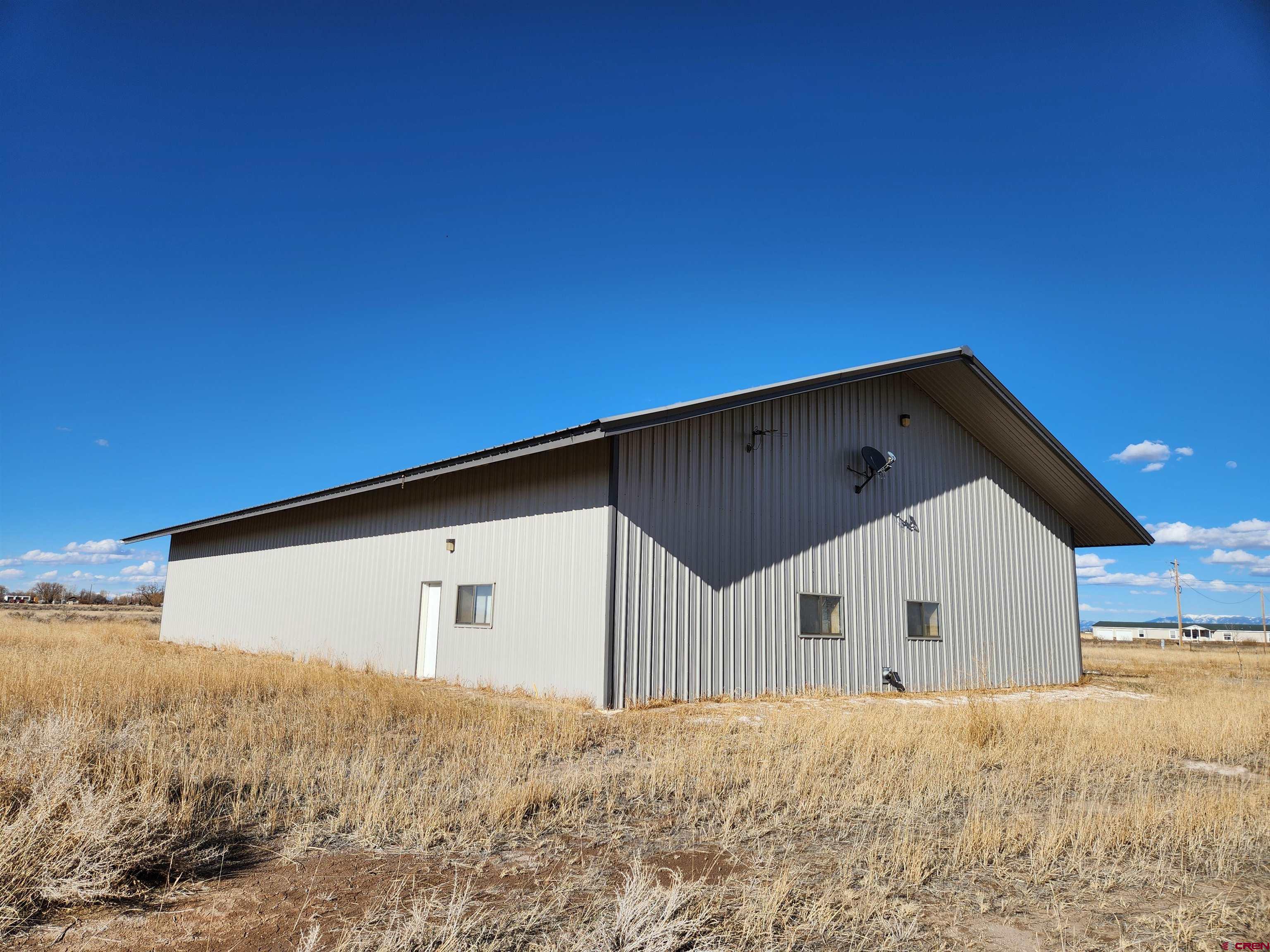 1935 Henderson Road Monte Vista, CO 81144 - Photo 2 of 23 a front view of a house with a yard