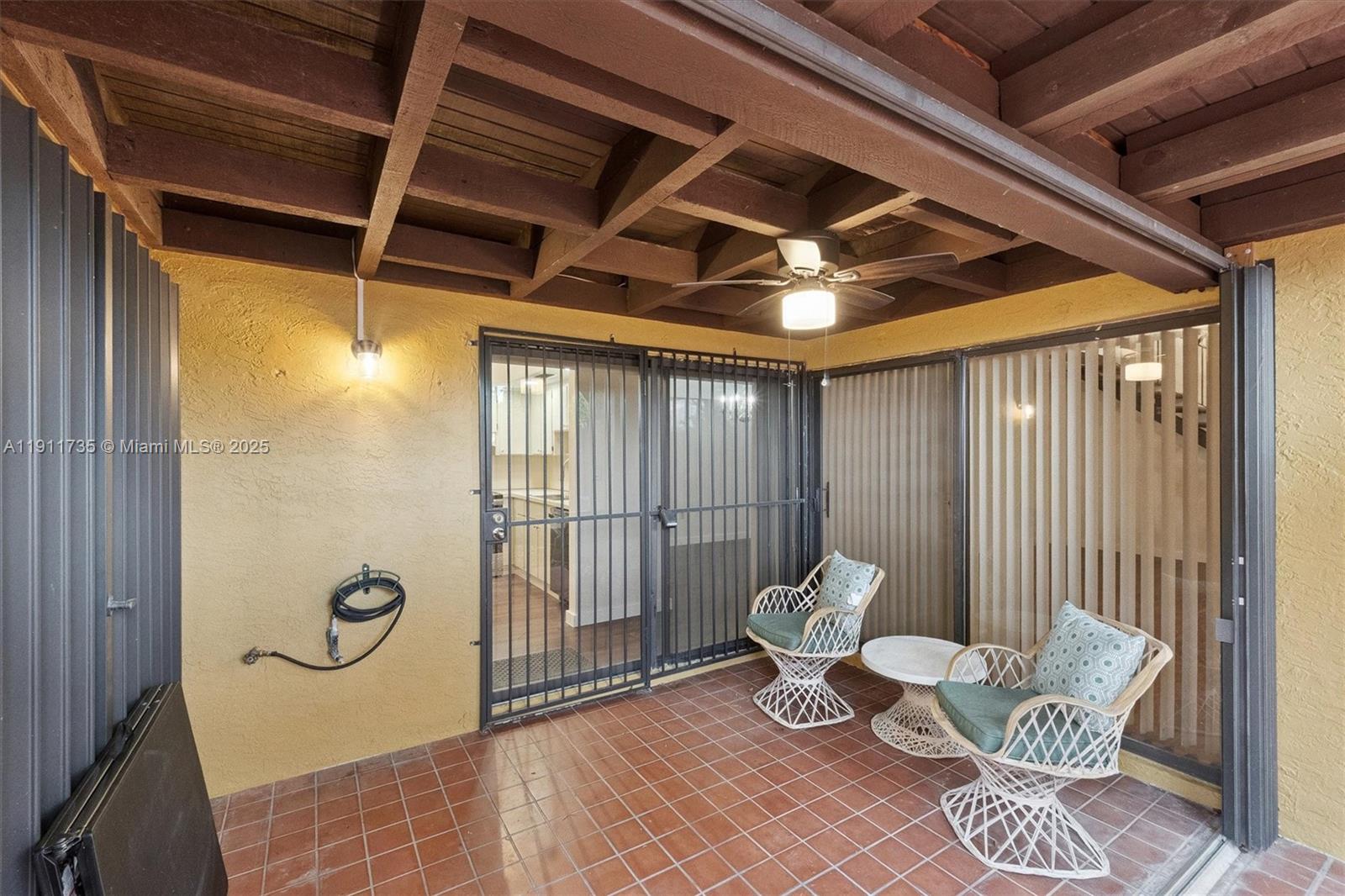 5975 Southwest 137th Avenue, Unit 702 Miami, FL 33183 - Photo 12 of 15 a view of a porch with furniture