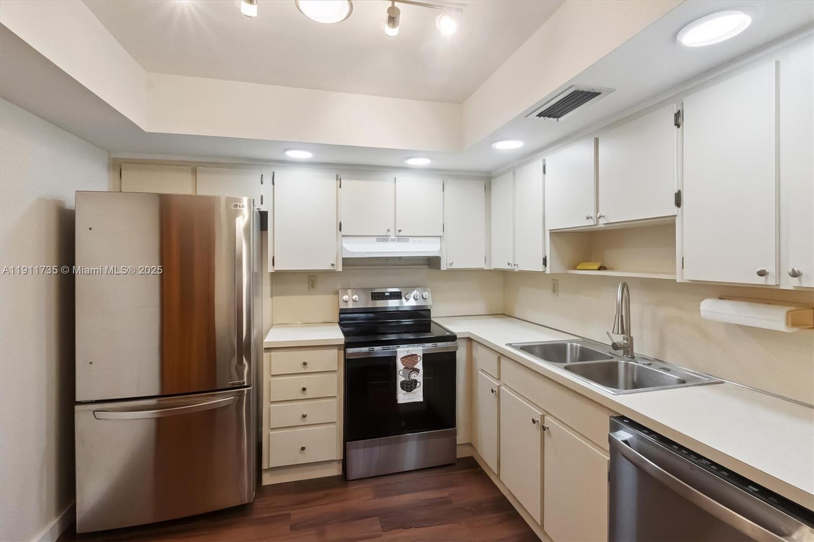 5975 Southwest 137th Avenue, Unit 702 Miami, FL 33183 - Photo 2 of 15 a kitchen with stainless steel appliances a refrigerator sink and cabinets