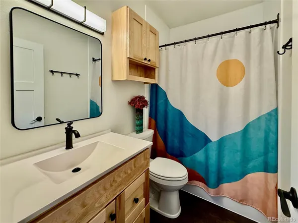 a bathroom with a sink mirror vanity and toilet