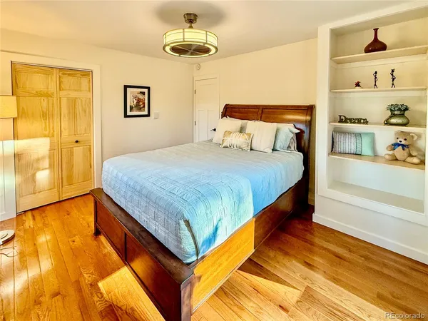 a bed sitting in a bedroom next to a bathroom