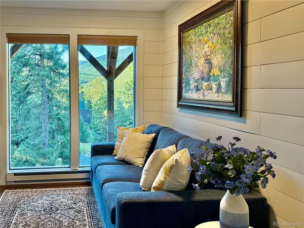 a living room with furniture and a potted plant