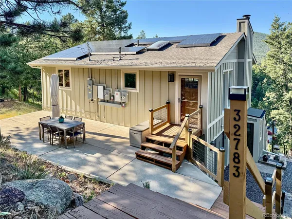 a view of a house with backyard porch and sitting area