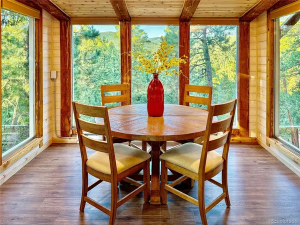 a dining room with furniture and wooden floor