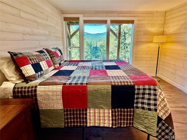 a bedroom with a bed and a window