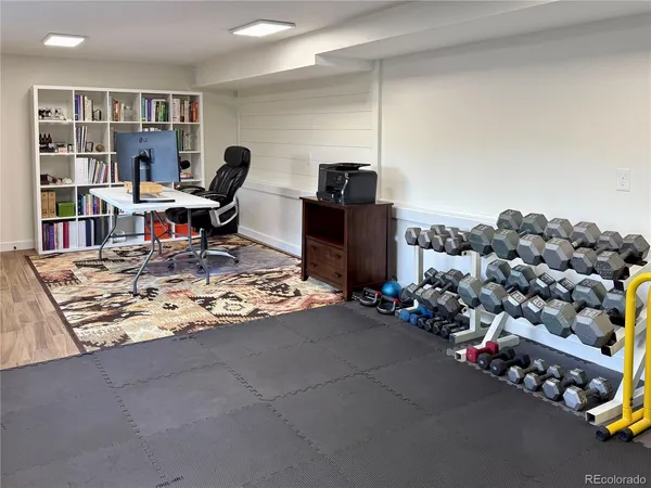 a living room with lots of furniture and a book shelf