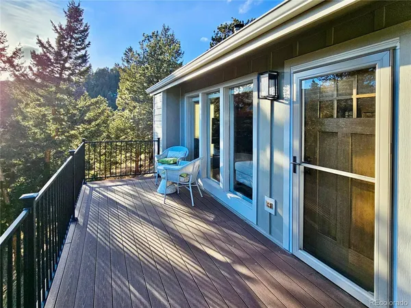a view of a balcony with chairs and wooden floor