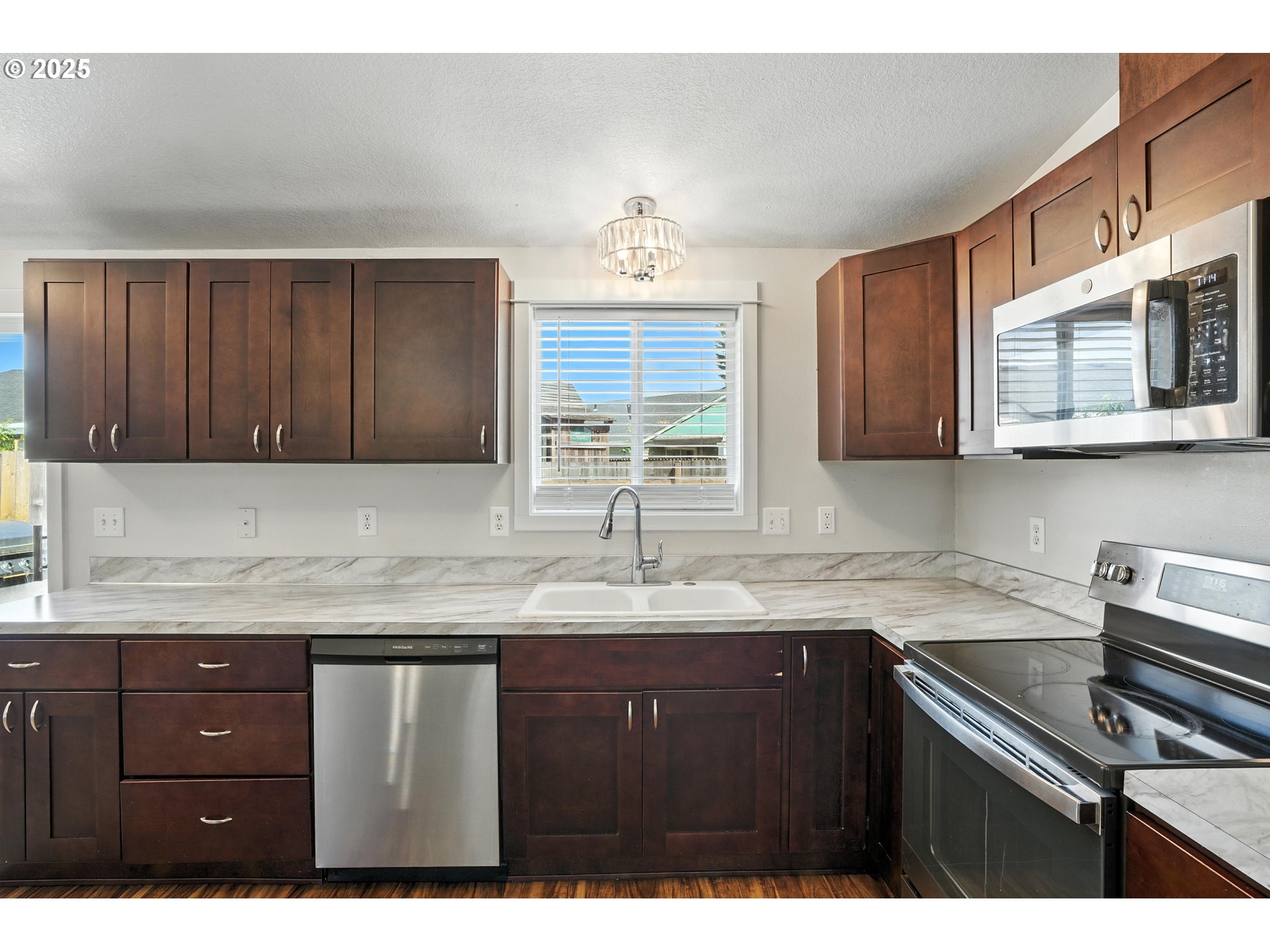 1608 Northwest 3rd Street Battle Ground, WA 98604 - Photo 11 of 26 a kitchen with a sink cabinets and a window