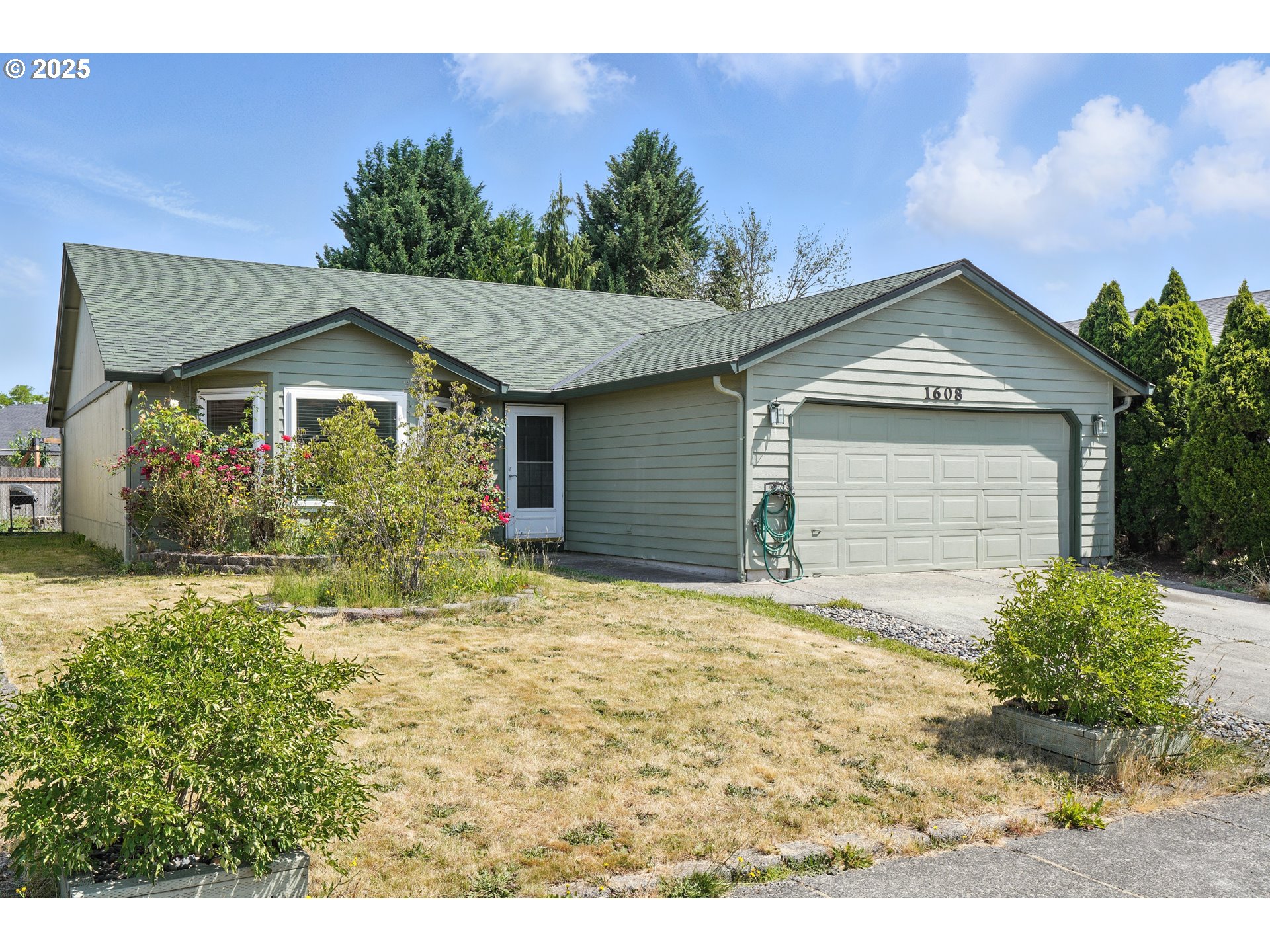 1608 Northwest 3rd Street Battle Ground, WA 98604 - Photo 3 of 26 a front view of a house with a yard and garage
