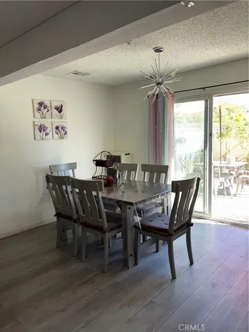 a dining room with furniture window and wooden floor