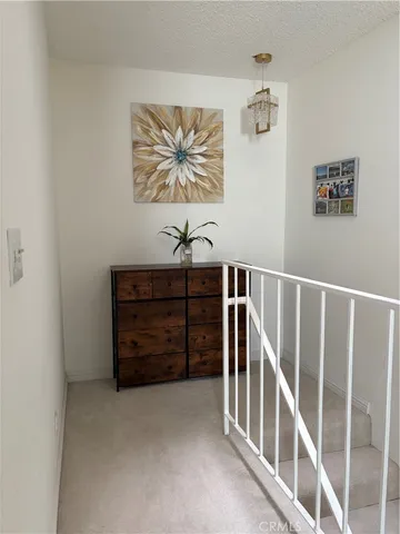 a view of a hallway with stairs