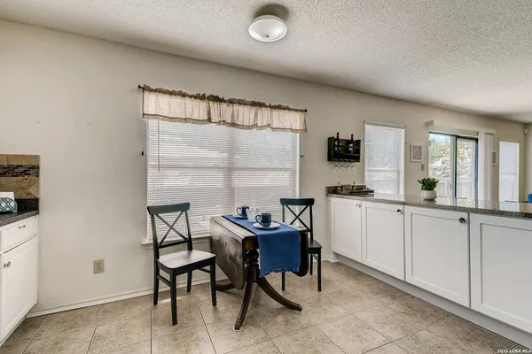 a kitchen with a table and chairs in it