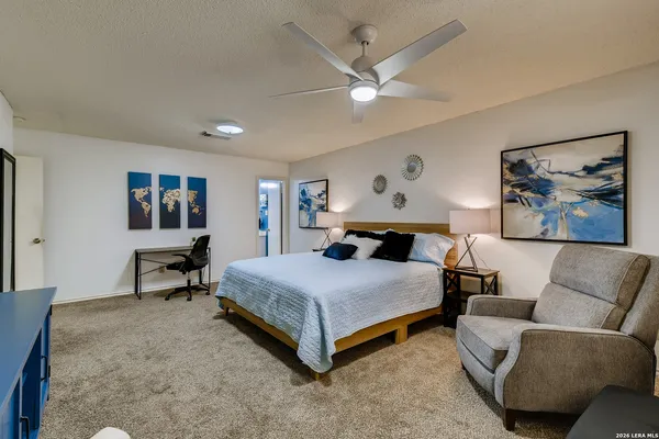 a bedroom with a bed and lamp