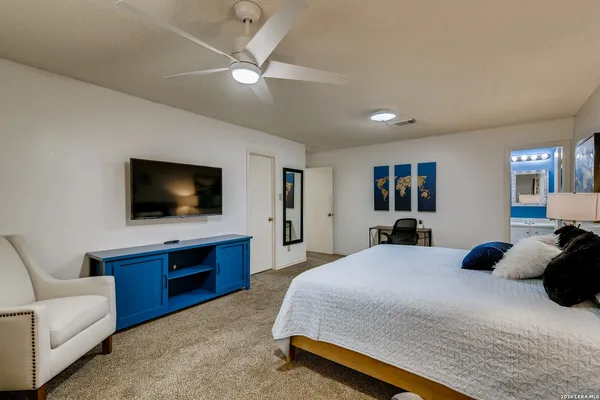 a bedroom with a large bed and a flat screen television