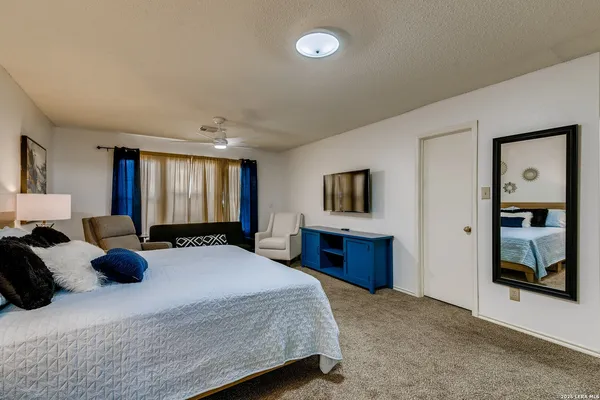 a bedroom with a large bed and a dresser