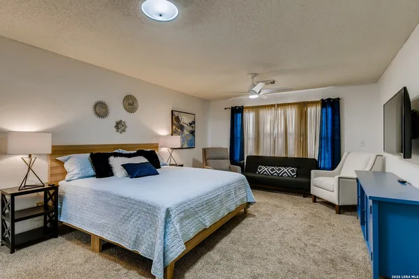 a bedroom with a bed and a couch