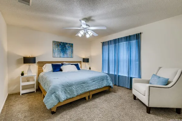 a bedroom with a bed couch and window