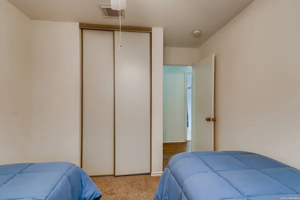 a bedroom with a bed and a dresser