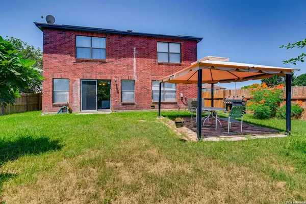 a view of a house with a yard and sitting area