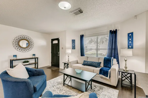 a living room with furniture and a large window