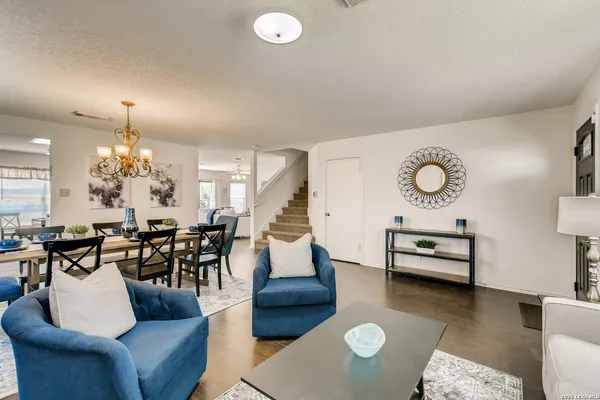 a living room with furniture and a chandelier