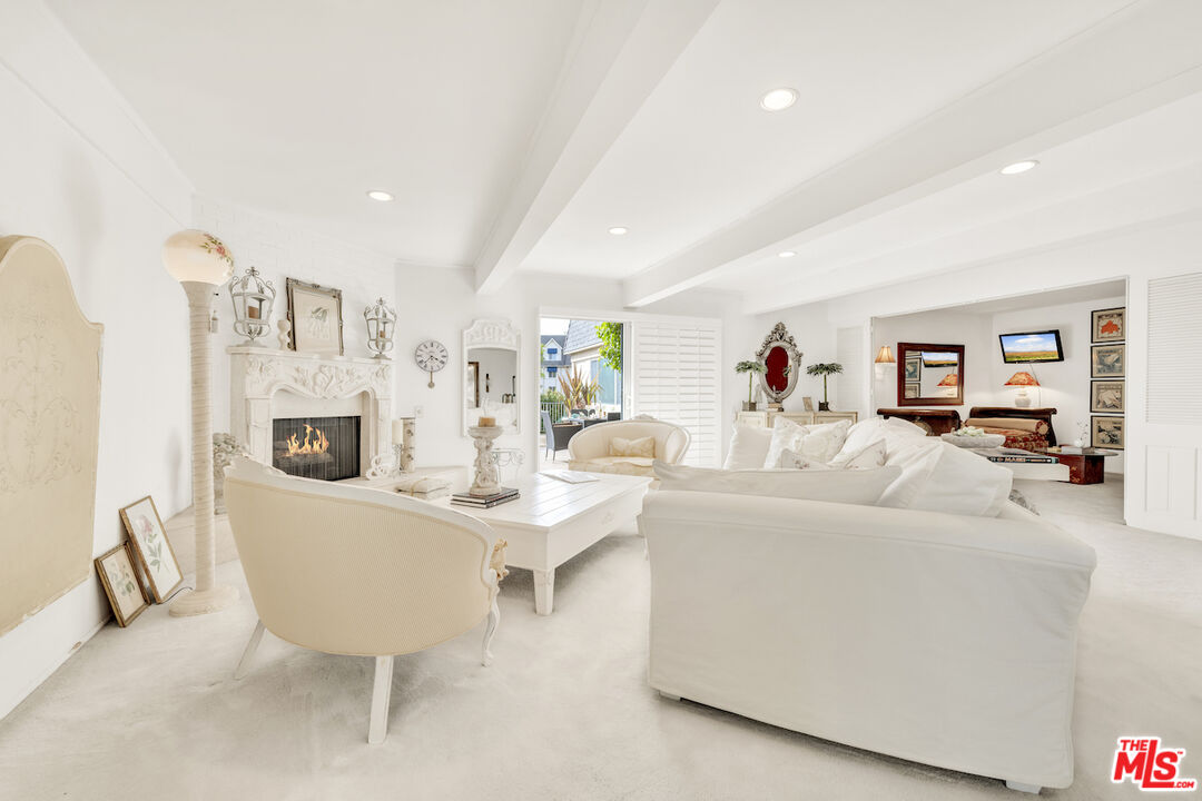 2385 Roscomare Road, Unit D17 Los Angeles, CA 90077 - Photo 1 of 22 a living room with furniture a fireplace and a table