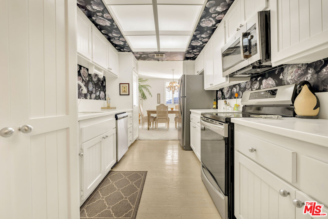 2385 Roscomare Road, Unit D17 Los Angeles, CA 90077 - Photo 4 of 22 a kitchen with cabinets and wooden floors
