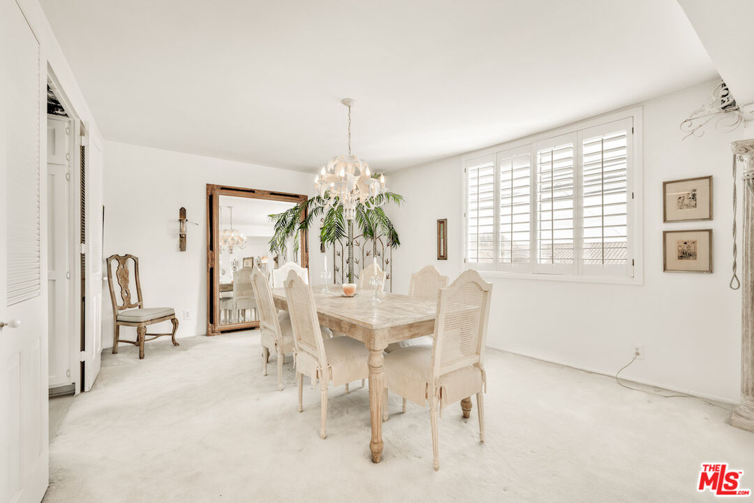 2385 Roscomare Road, Unit D17 Los Angeles, CA 90077 - Photo 7 of 22 a dining room with furniture a chandelier and a rug