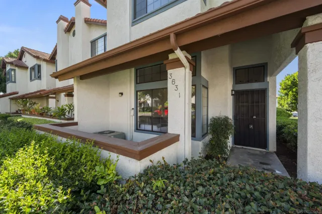 front view of a house with potted plants