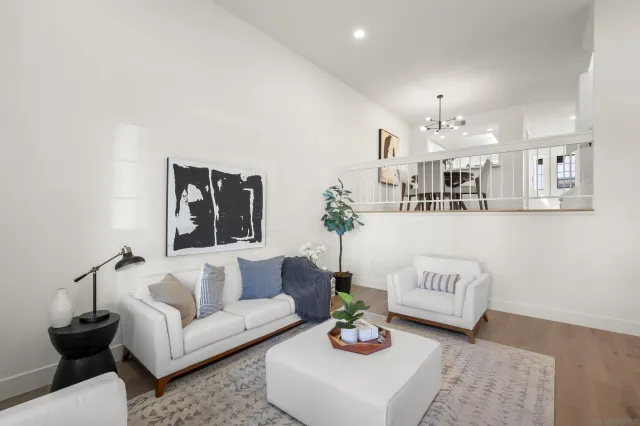 a living room with furniture and kitchen view