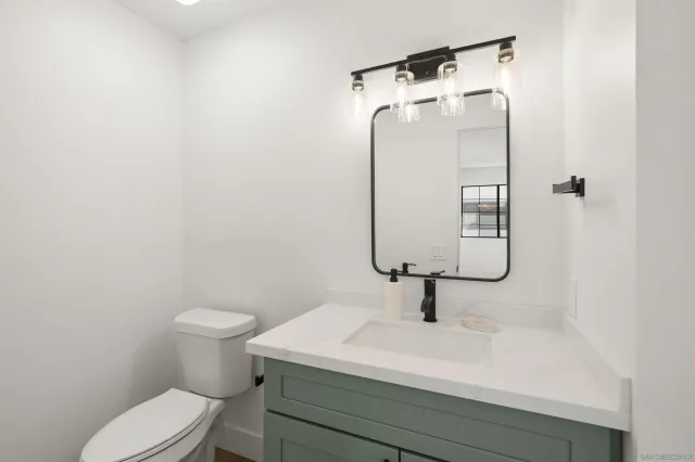 a bathroom with a toilet sink and vanity