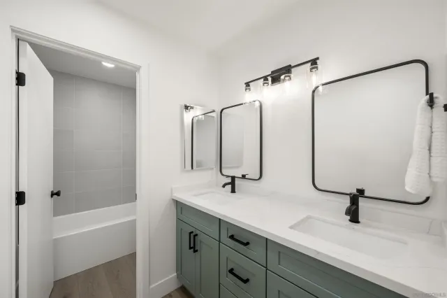 a bathroom with a double vanity sink and a mirror