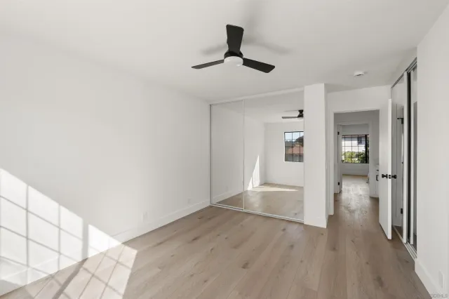 a view of an empty room and wooden floor