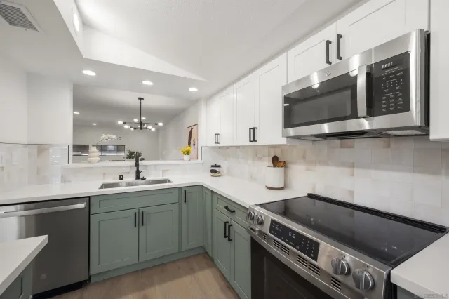 a kitchen with a sink stainless steel appliances and cabinets