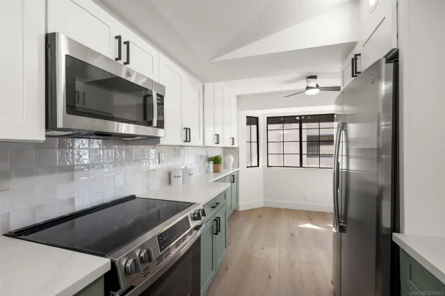a kitchen with a stove a sink and a microwave