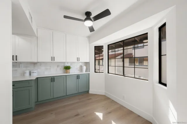 a kitchen with a sink cabinets and wooden floor