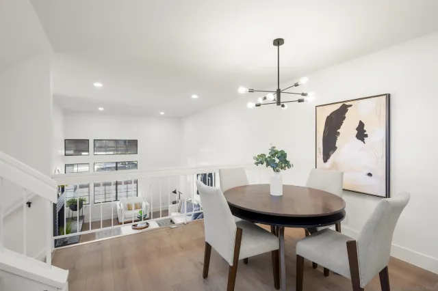 a view of a dining room with furniture and chandelier