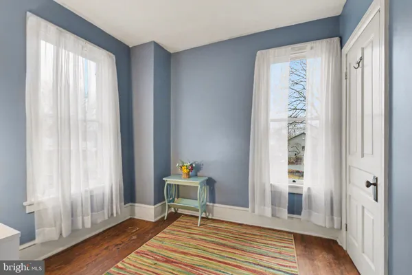 a bedroom with furniture and a wooden floor