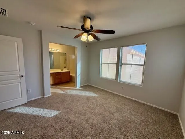 an empty room with windows and cabinet