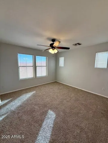 a view of a livingroom with a ceiling fan and window