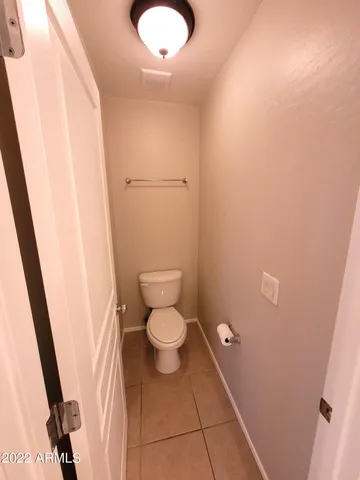 a bathroom with a granite countertop toilet and sink