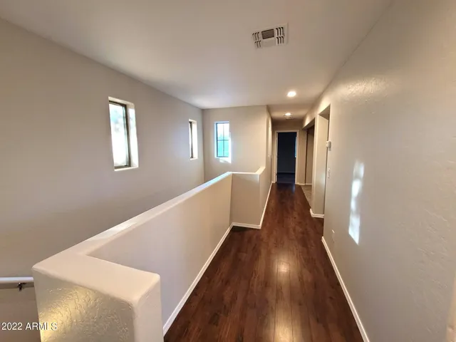 a view of entryway and hall with wooden floor