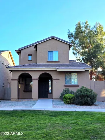 a view of a house with a yard and a fireplace