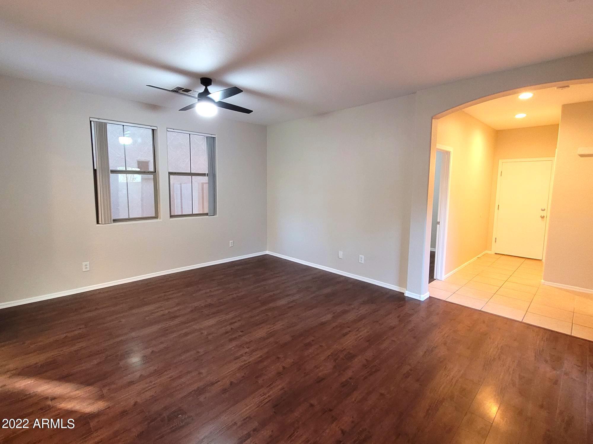 1930 East Harrison Street Gilbert, AZ 85295 - Photo 3 of 31 a view of an empty room with wooden floor and a window