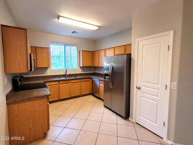 a kitchen with stainless steel appliances granite countertop a refrigerator sink and cabinets