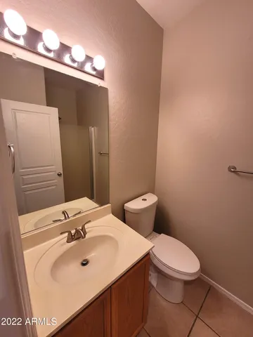 a bathroom with a sink toilet and mirror