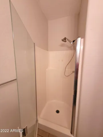 a bathroom with a glass shower door