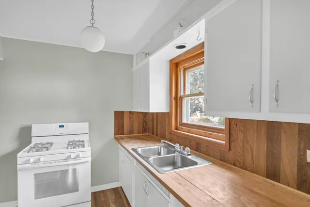 a kitchen with a stove a sink and a microwave