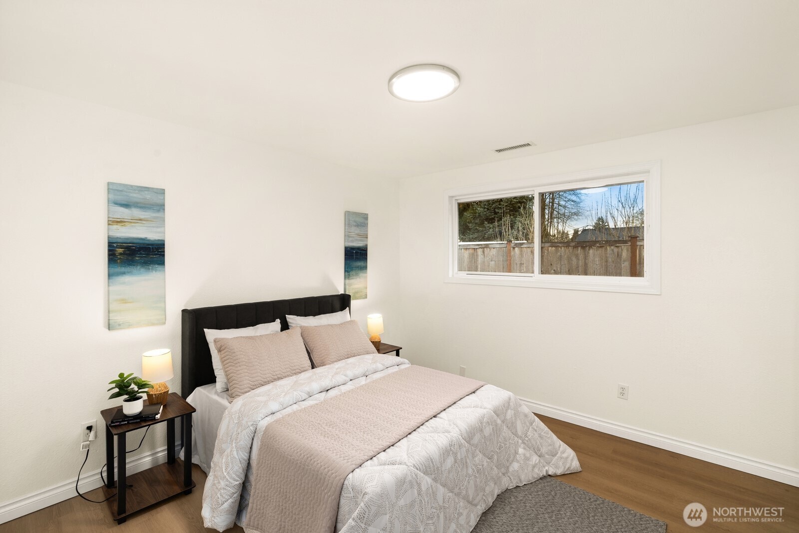 506 Train Street Southeast Orting, WA 98360 - Photo 14 of 24 a bedroom with a bed and a painting on the wall