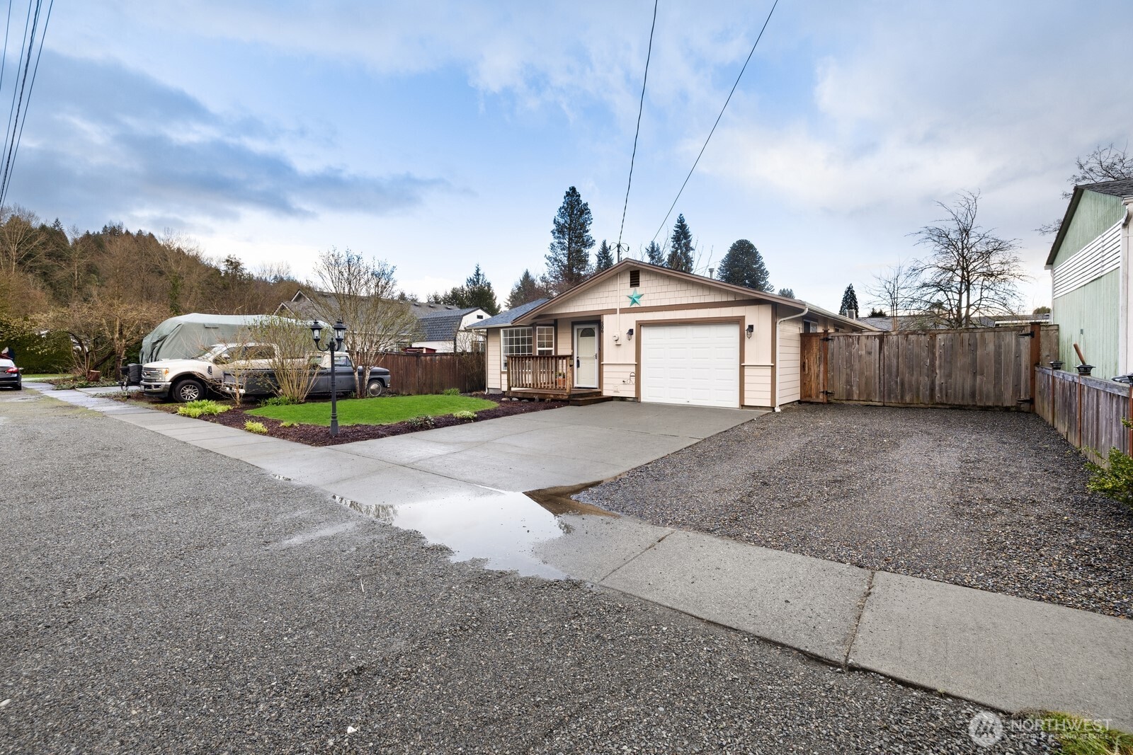 506 Train Street Southeast Orting, WA 98360 - Photo 3 of 24 a view of a house with a yard and fence